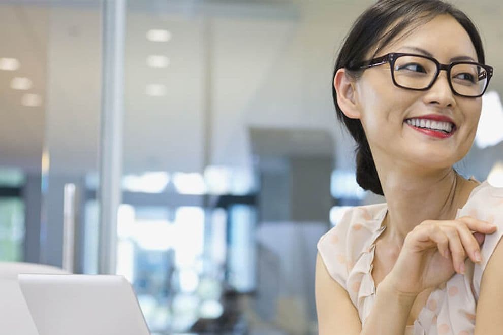 You woman using a computer in an office.